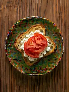 Tostada de pan de cristal con queso fresco y tomate