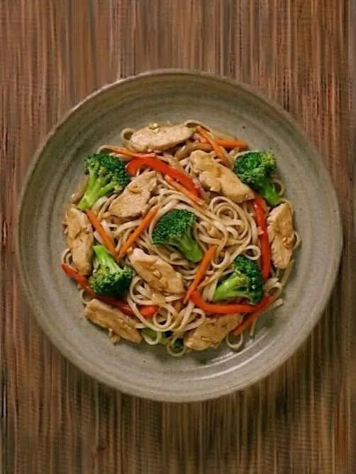 Salteado de pollo con fideos de arroz y brócoli